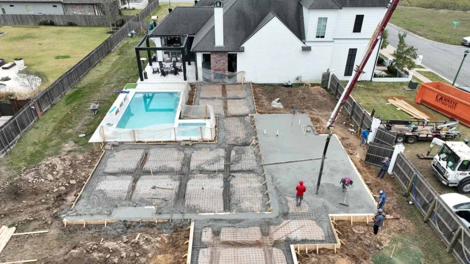 District Concrete crew power-troweling a freshly poured residential foundation slab in Acadiana
