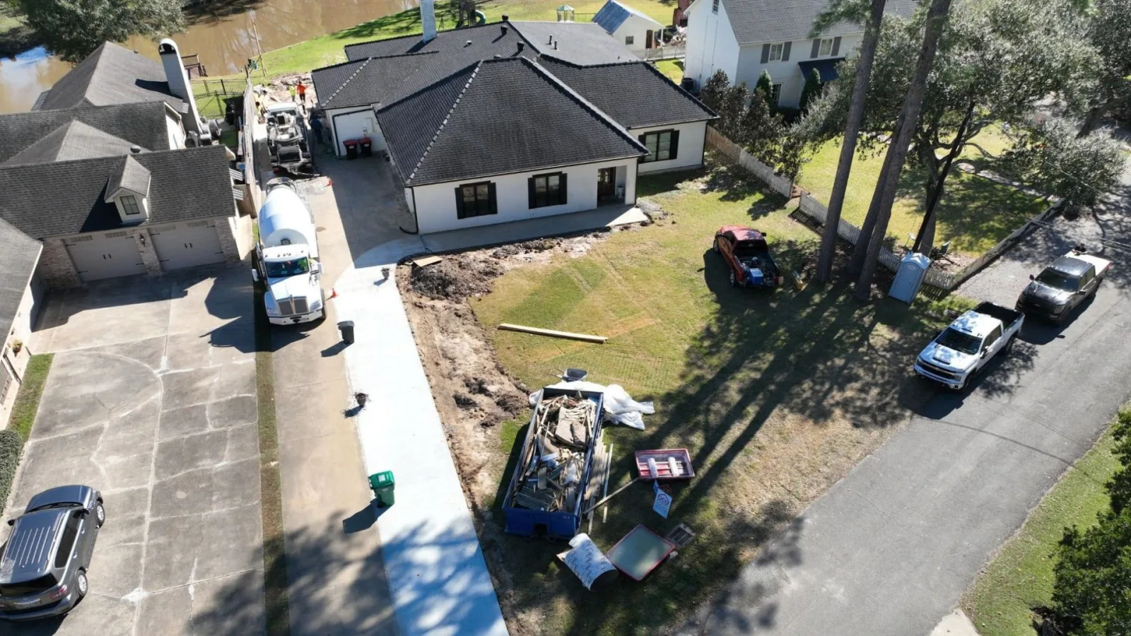 Concrete pump truck placing a reinforced foundation slab on a new construction site near Lafayette, Louisiana