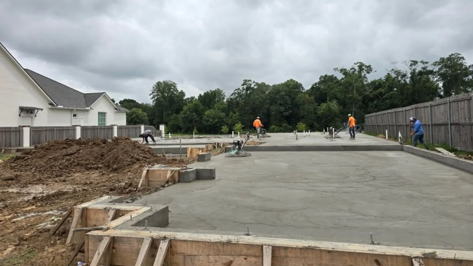 Large reinforced concrete patio being poured beside a pool at a Youngsville, Louisiana home